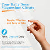 Magnesium citrate supplement capsule daily dose shown with hand holding a capsule