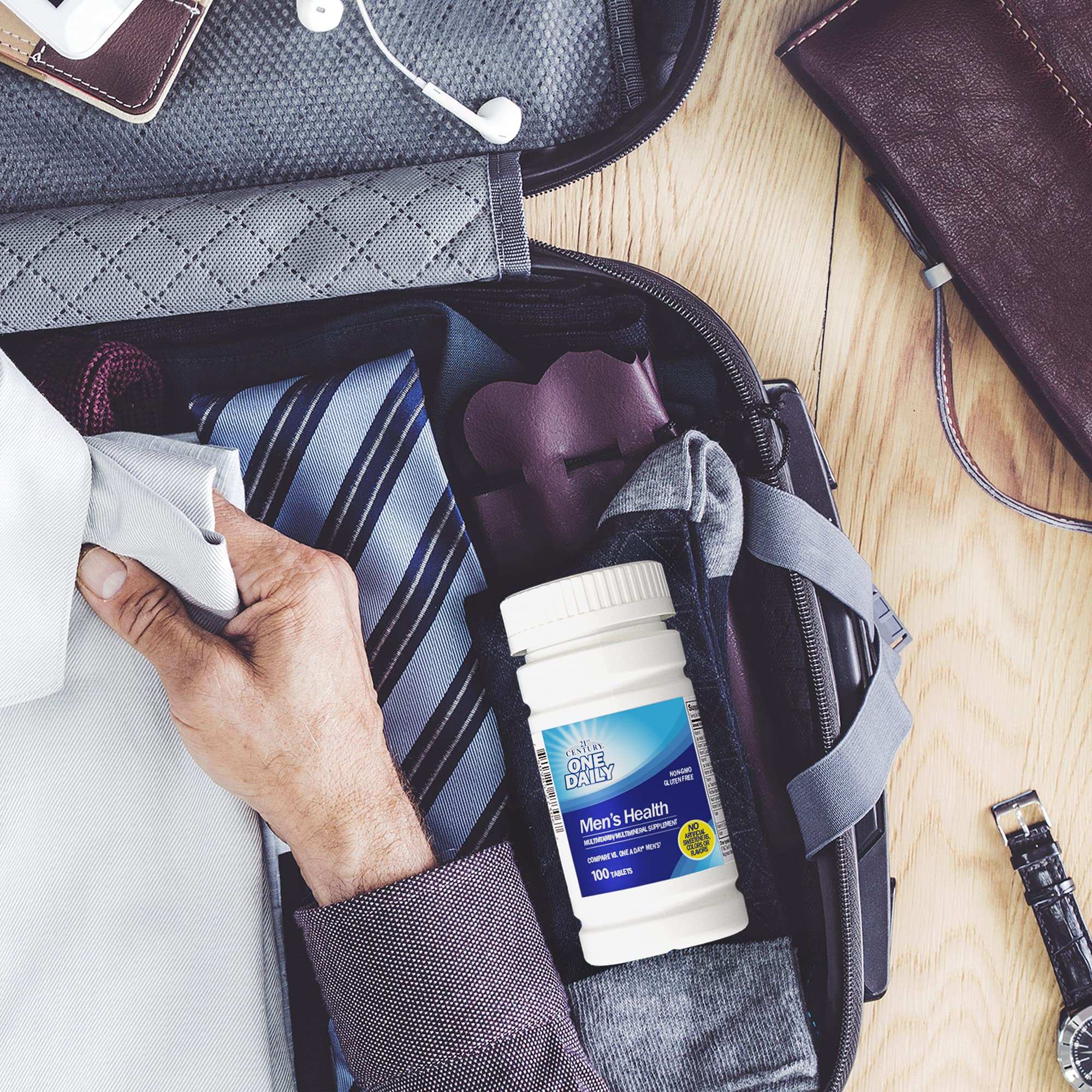 21st Century Men's Daily Multivitamin Tablets in a travel bag with clothing and accessories