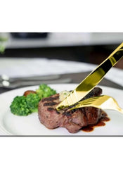 Huitich 24-piece dining flatware set with gold fork and knife cutting steak on white plate with broccoli