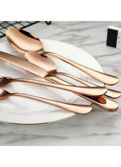 Huitich 24-piece dinnerware set with stand featuring rose gold flatware on a white plate