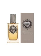 Eau de parfum bottle with gold liquid, silver cap, and heart emblem on label