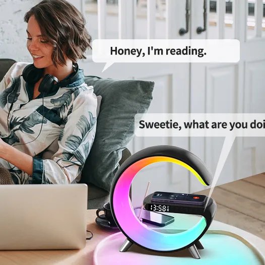 Huitich Bluetooth speaker 3-in-1 alarm clock with RGB light showing colorful display on wooden table