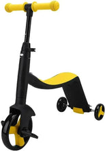 Kids tricycle balance bike with yellow foam handlebars, black frame, and three small wheels