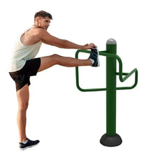 Leg flexibility trainer in use: person stretching leg against green support bars