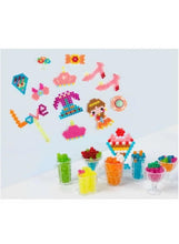 Water bead craft set showing small bead creations, plus cups and charms in colors