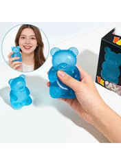 Blue gummy bear squishy stress toy in hand, small rounded bear figure.