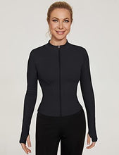 Black long-sleeve sports top with half-zip front and fitted side seams