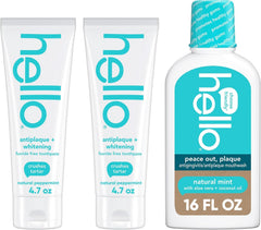 Antiplaque whitening fluoride-free toothpaste tubes and natural mint mouthwash bottle