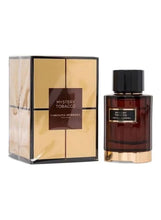 Eau de parfum bottle and matching box, black cap, amber-brown glass with gold base