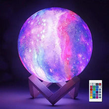 Glowing galaxy moon lamp with purple-blue light on wooden stand and remote control