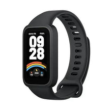 Black fitness tracker close side profile with lit screen and band ventilation holes