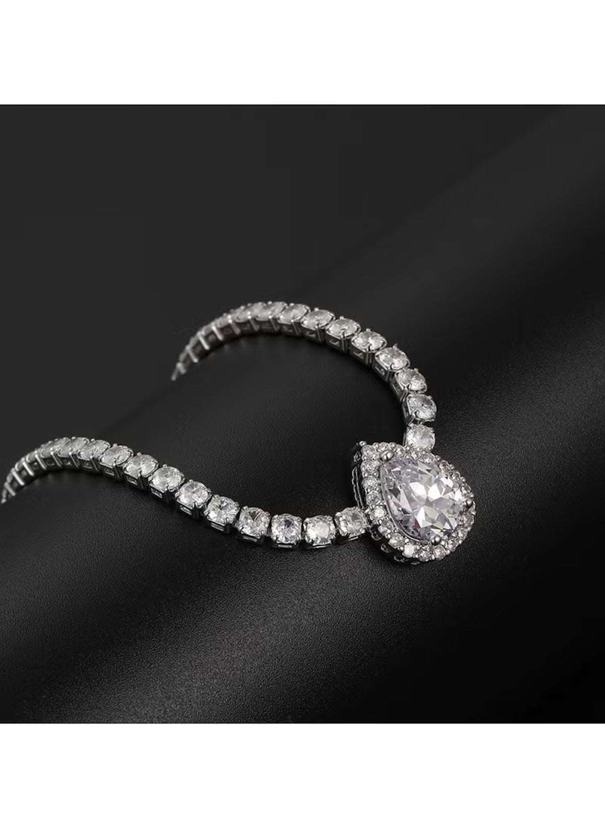 Huitich 42cm silver crystal pendant necklace with teardrop center stone on a black background