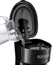 Black+Decker coffee maker with lid open, pouring into stainless mug container