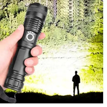 Black LED flashlight held in hand with side mode button