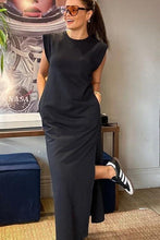 Black sleeveless maxi dress with scoop neck and side slit, long straight silhouette