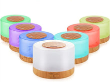 Aroma diffuser with white housing, wooden base, and circular lid, surrounded by colorful LED units