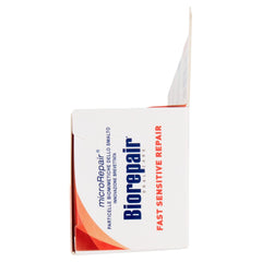 White Biorepair box with blue logo and orange accents open flap showing Biorepair toothpaste for sensitive teeth.