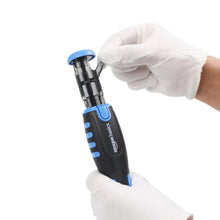 Magnetic ratchet screwdriver held with white gloves; blue-and-black handle and bit set