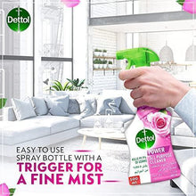 Hand holding Dettol Power all purpose cleaner spray bottle with fine-mist trigger