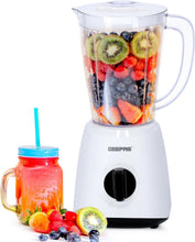 White blender with clear jar filled with sliced fruit and berries; black control dial