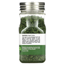 Glass jar of organic parsley flakes with ingredient label on the back