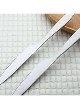 Stainless steel dinner knives with serrated edges and pointed tips.