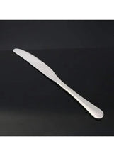 Stainless steel dinner knife with smooth handle and curved serrated blade.