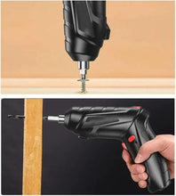 Cordless screwdriver driving a screw into wood, black body with red switch