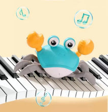 Blue crab toy with orange claws crawling on piano keys, with glowing light icons