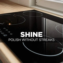Black glass cooktop surface with circular burner rings