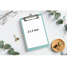 Small plastic clipboard with metal clip, light teal, 6 x 9 inch writing board.