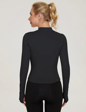 Black long-sleeve sports top, half-zip front, back view