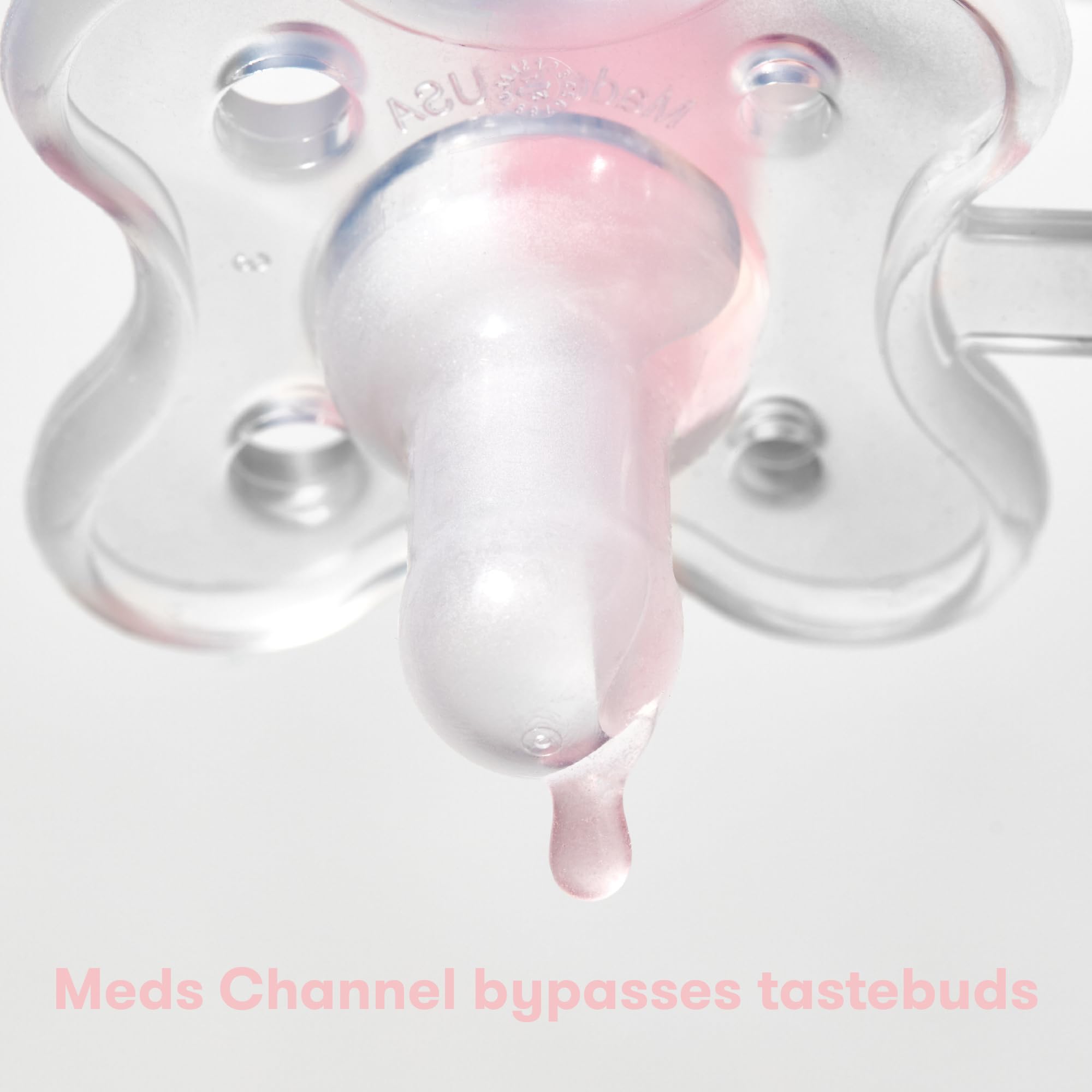 Close up of Frida Baby MediFrida Accu-Dose Pacifier nipple with a medicine droplet showing dosing channel