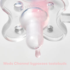 Close up of Frida Baby MediFrida Accu-Dose Pacifier nipple with a medicine droplet showing dosing channel