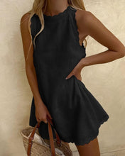 Black sleeveless halter dress with scalloped hem and gathered waist