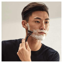 Shaving razor with Fusion5 blade cartridge on face with shaving foam