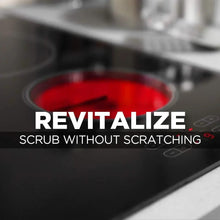 Black glass cooktop with circular burner areas, cleaned and polished surface
