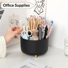 Rotating desk pencil holder with ribbed black base filled with pens and office supplies