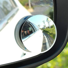 Installed round convex blind spot mirror reflecting the roadway