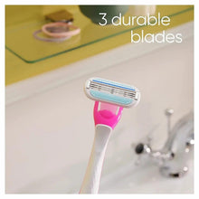Disposable razor head with three blades and pink handle, close-up