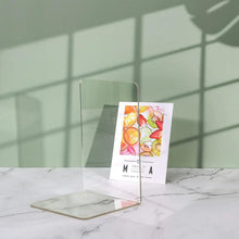 Clear acrylic bookend holding a small card inside the stand.