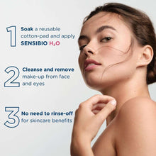 Woman applying cleanser with cotton pad to cheek, face close-up
