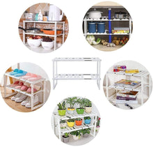 White expandable under-sink storage rack shown with pantry and kitchen items