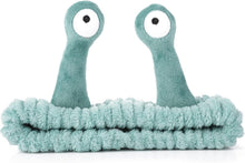 Teal plush snail-shaped face wash headband with soft elastic band and cartoon eyes