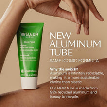 Weleda Skin Food ultra-rich cream tube with hand holding it, green cap and white body
