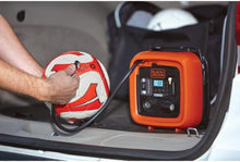 Black+Decker 12V inflator powering a soccer ball in a car trunk