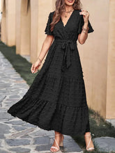 Black wrap V-neck maxi dress with tie belt and tiered flutter skirt