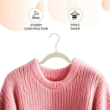 Ivory velvet suit hanger holding a light pink sweater