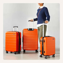 Orange hardside spinner luggage set with three ABS suitcases and telescoping handles