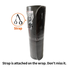 Packaged rolled dark gray yoga mat with carrying strap attached to wrap